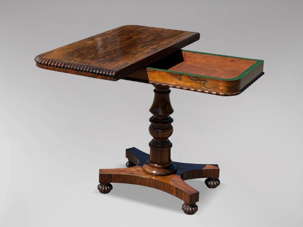 A 19th-century William IV rosewood fold-over card table featuring a gadrooned rim, a turned column stem, and a concave platform base with carved feet. View III