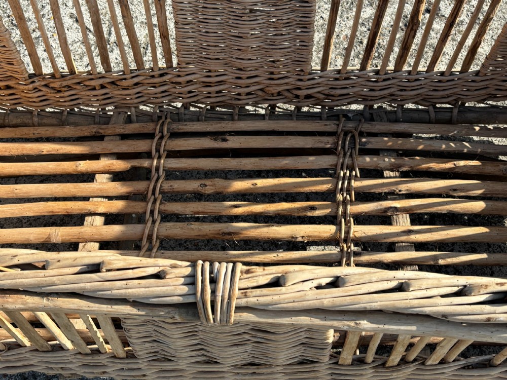 A large rectangular French wicker basket featuring open vertical weave, woven loop handles, and wooden runner skids along the base. View IV
