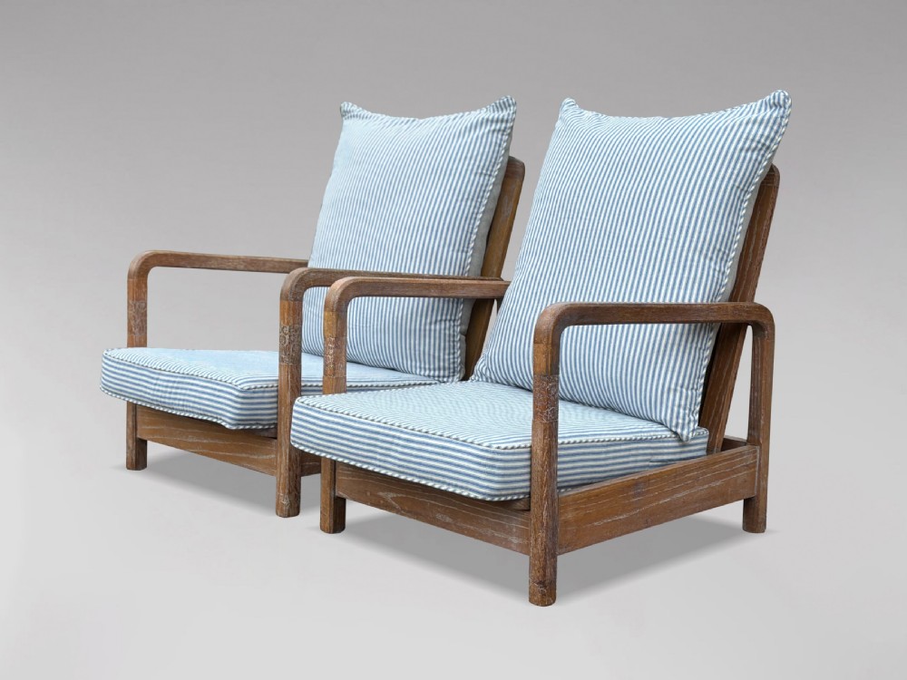 PAIR OF RECLINING ARMCHAIRS IN THE MANNER OF LIBERTY & CO