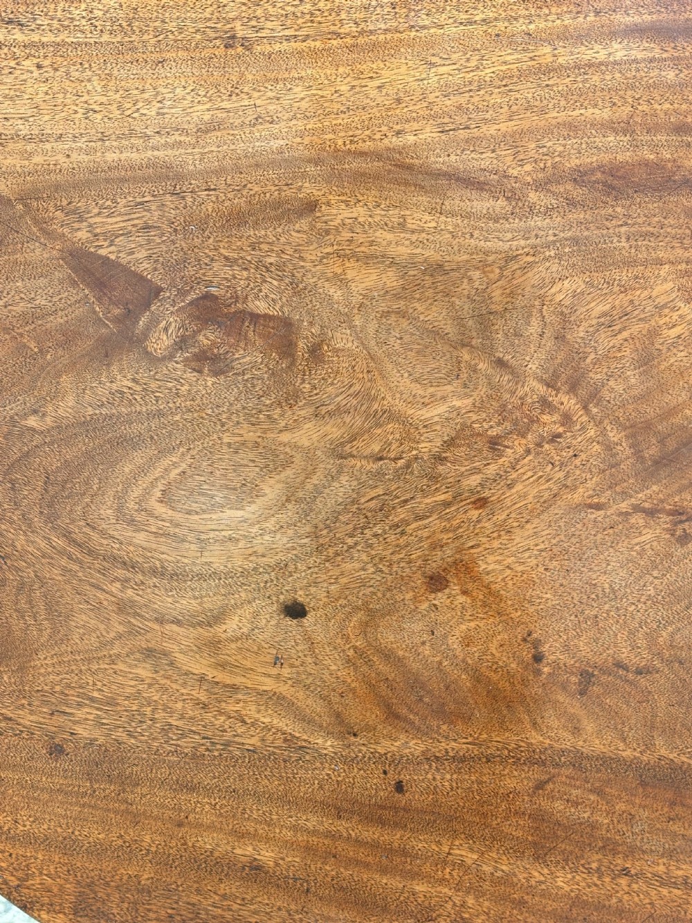 An 18th-century George III mahogany tripod table with its circular top tilted vertically above a turned central column and three cabriole legs. View V