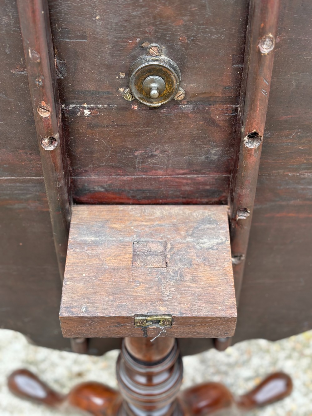 An 18th-century George III mahogany tilt-top tripod table shown in the vertical position with a carved pie-crust rim, turned pedestal, and cabriole legs. View IV