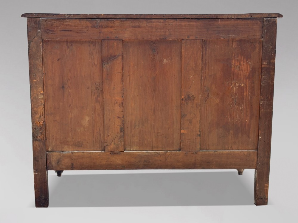 An eighteenth-century French Louis XV walnut commode featuring three carved drawers with rococo brass handles and cabriole legs. View III