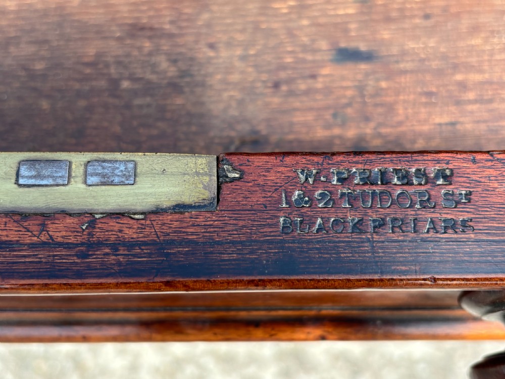 An 18th-century mahogany library table featuring a black leather top insert, frieze drawers with wooden knob handles, and turned, fluted legs on brass castors. View XI