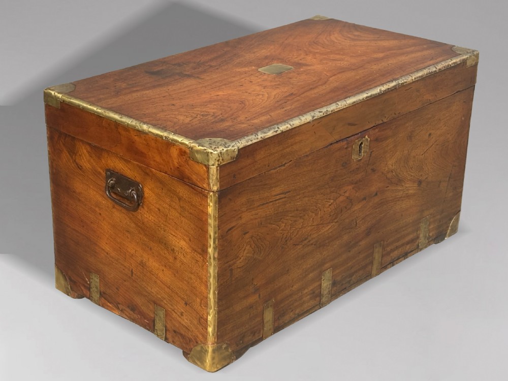 A rectangular 19th-century camphor wood campaign trunk with brass corner strapping, edge binding, a central flush plaque, and iron side handles. View VIII