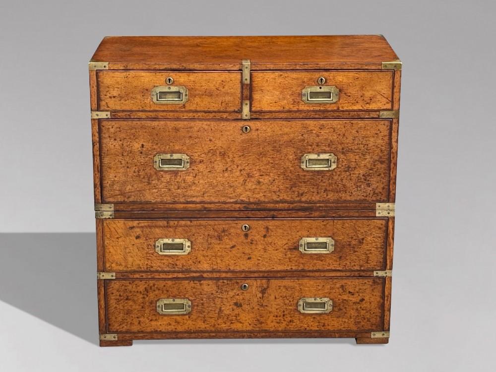 A nineteenth-century oak military campaign chest of drawers featuring brass corner straps, recessed flush handles, and turned feet. View II