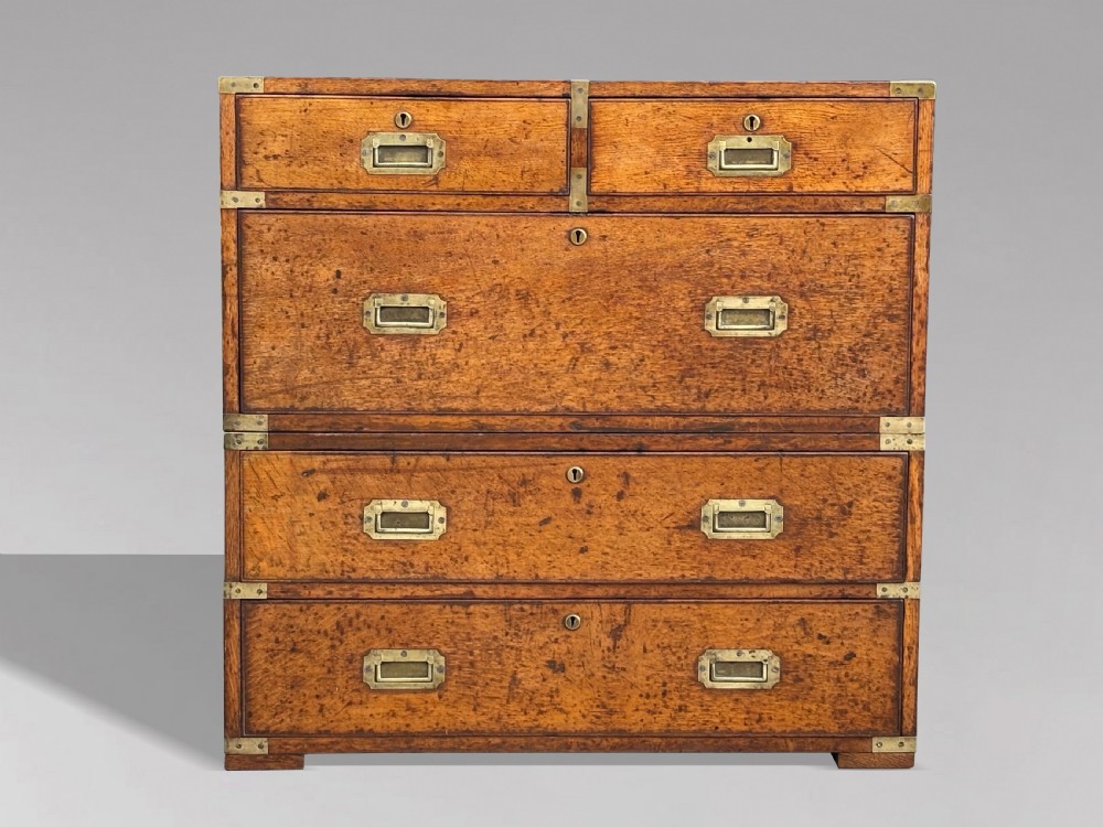 A nineteenth-century oak military campaign chest of drawers featuring brass corner straps, recessed flush handles, and turned feet. View III
