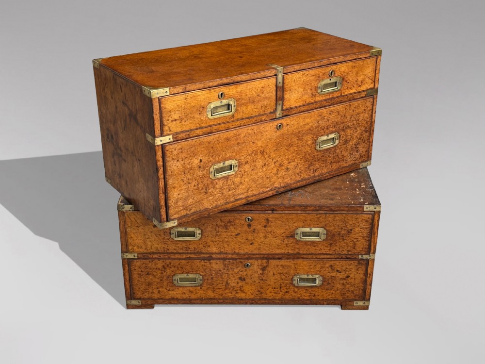 A nineteenth-century oak military campaign chest of drawers featuring brass corner straps, recessed flush handles, and turned feet. View V
