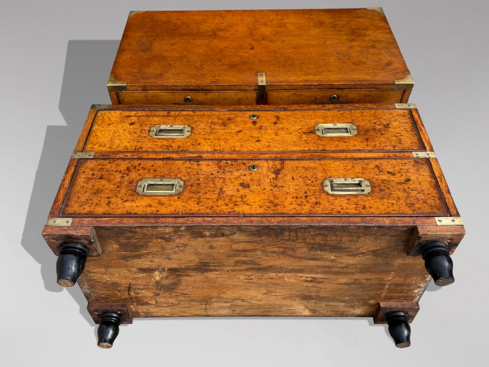 A nineteenth-century oak military campaign chest of drawers featuring brass corner straps, recessed flush handles, and turned feet. View IX
