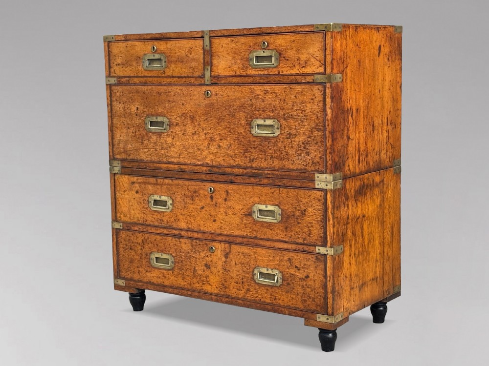 A nineteenth-century oak military campaign chest of drawers featuring brass corner straps, recessed flush handles, and turned feet. View XI