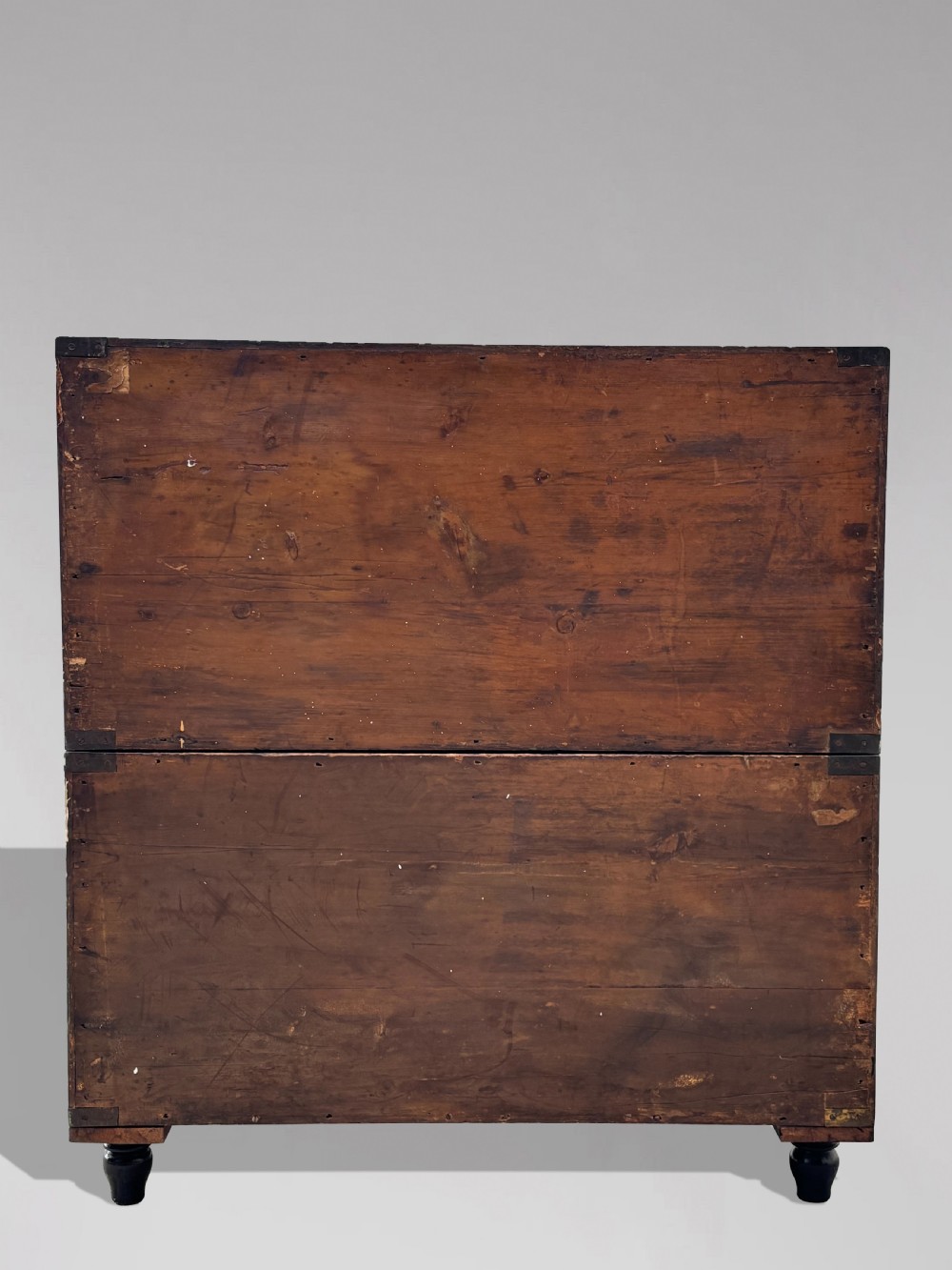 A nineteenth-century oak military campaign chest of drawers featuring brass corner straps, recessed flush handles, and turned feet. View XII