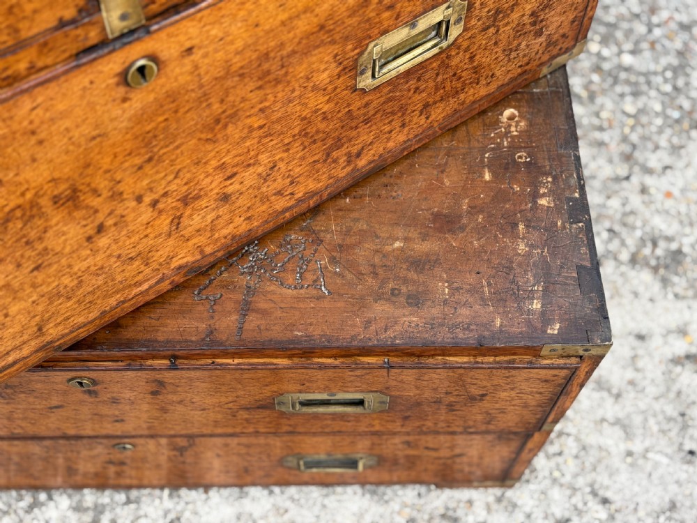 A nineteenth-century oak military campaign chest of drawers featuring brass corner straps, recessed flush handles, and turned feet. View XIV