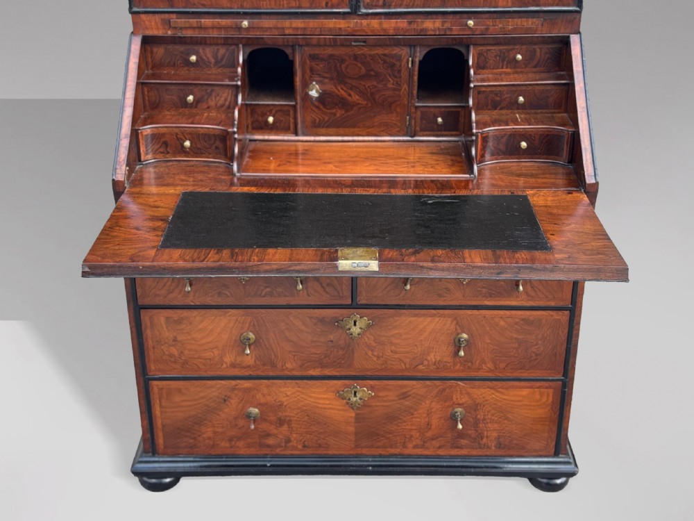 An 18th-century George I walnut bureau bookcase featuring arched panelled upper doors, a slant-front desk, and graduated lower drawers. View IV