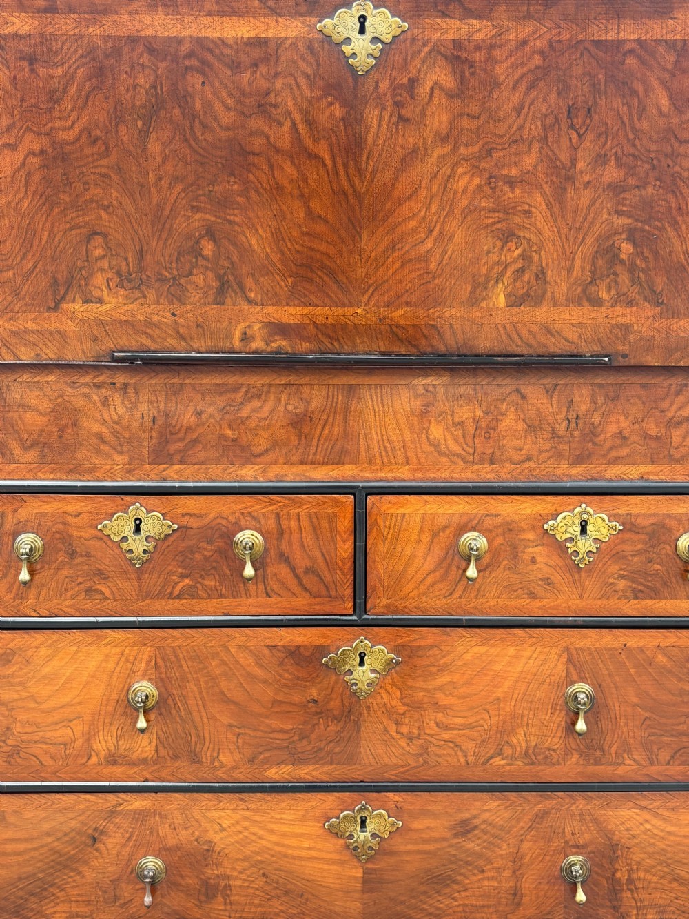 An 18th-century George I walnut bureau bookcase featuring arched panelled upper doors, a slant-front desk, and graduated lower drawers. View VI