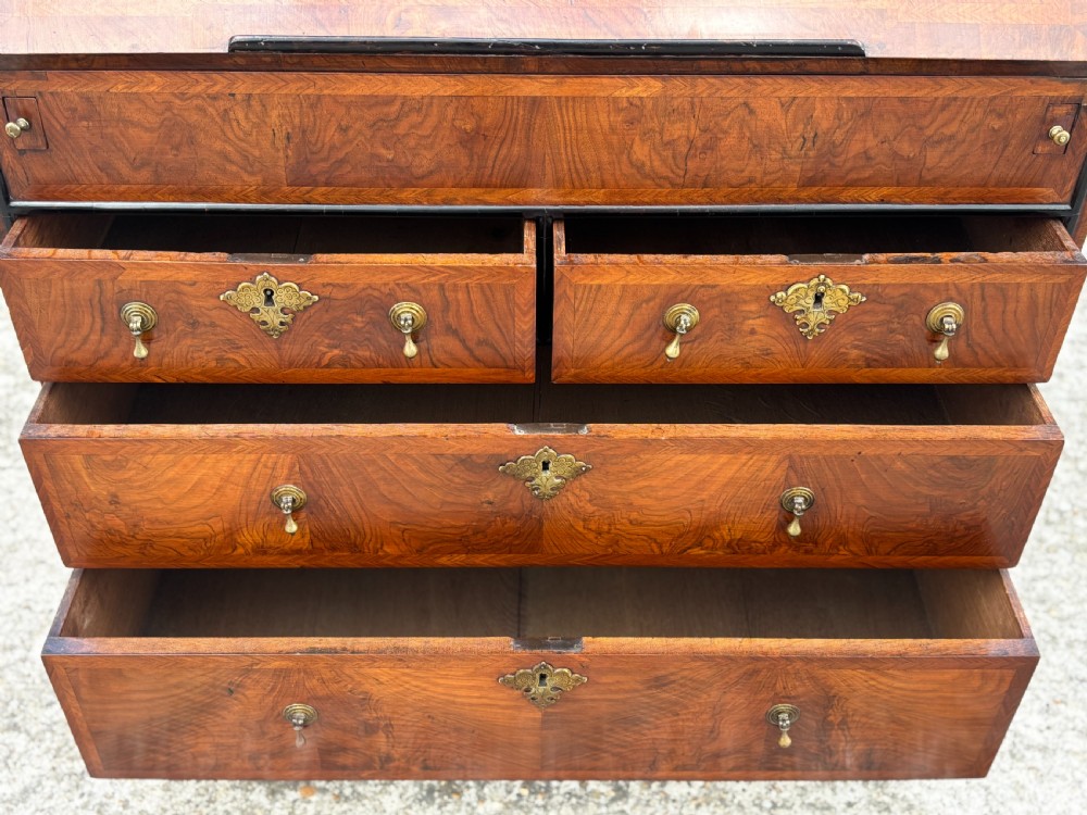 An 18th-century George I walnut bureau bookcase featuring arched panelled upper doors, a slant-front desk, and graduated lower drawers. View IX