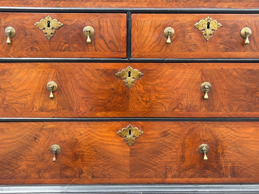 An 18th-century George I walnut bureau bookcase featuring arched panelled upper doors, a slant-front desk, and graduated lower drawers. View XII