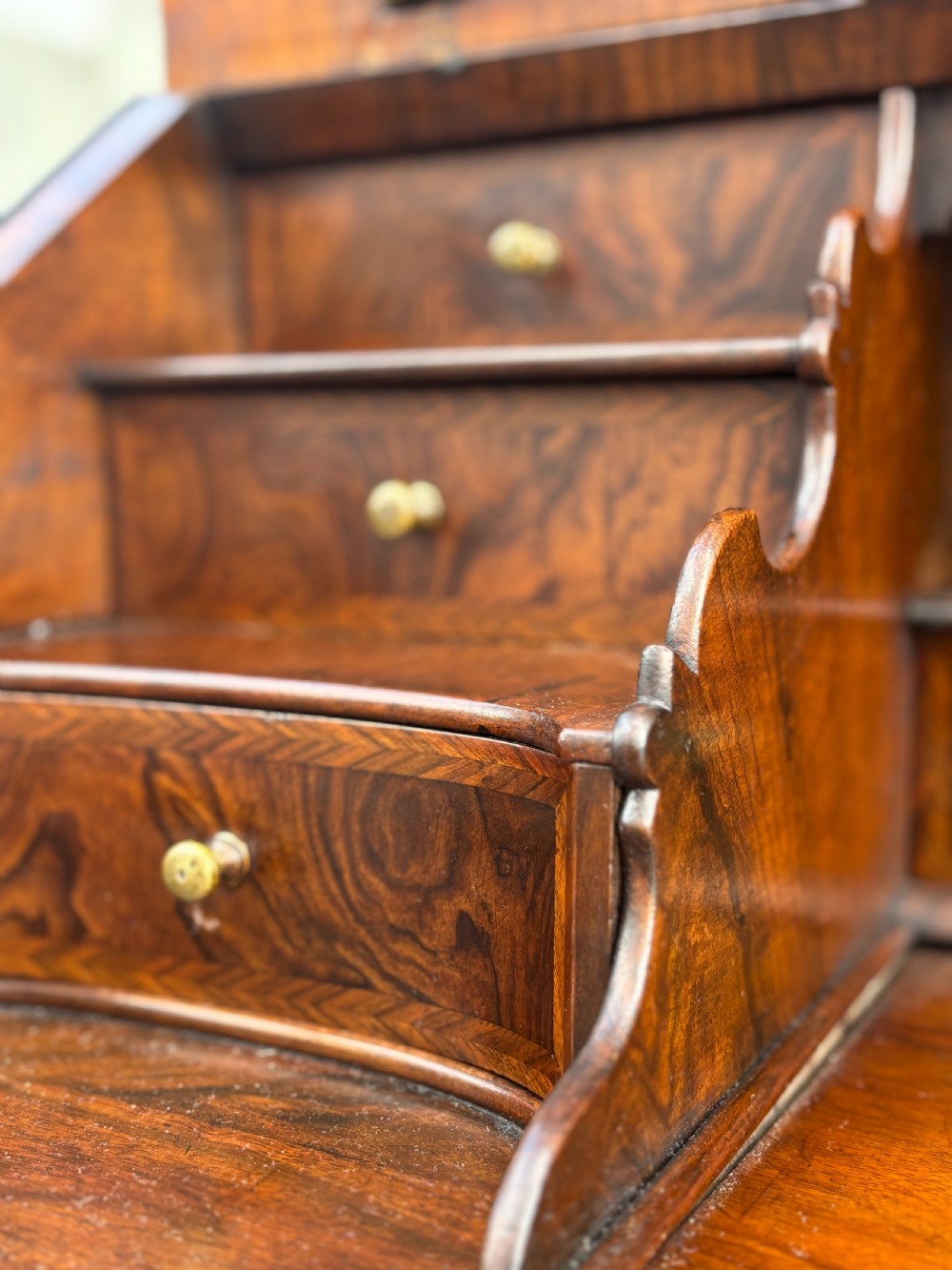 An 18th-century George I walnut bureau bookcase featuring arched panelled upper doors, a slant-front desk, and graduated lower drawers. View XIV