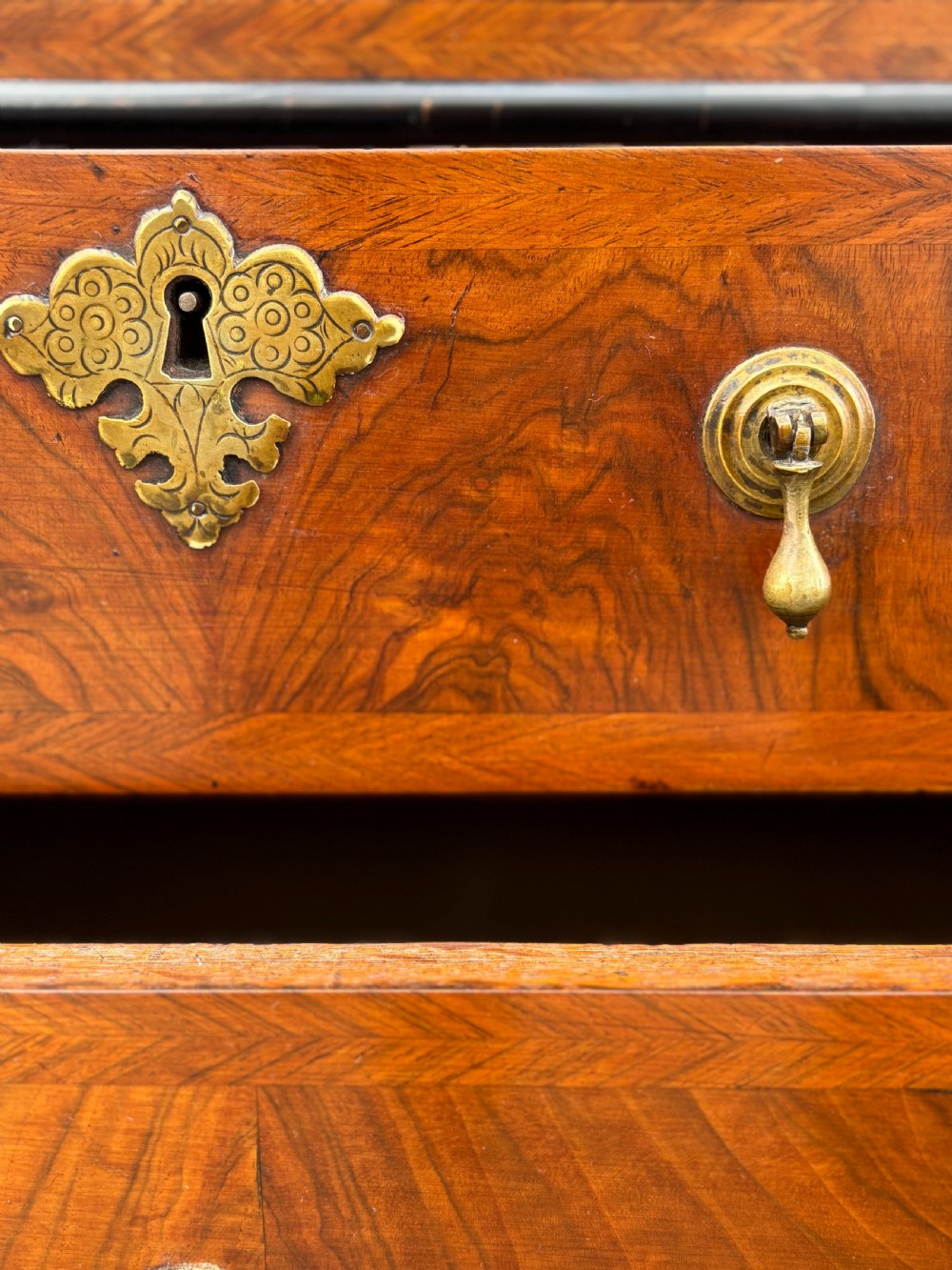 An 18th-century George I walnut bureau bookcase featuring arched panelled upper doors, a slant-front desk, and graduated lower drawers. View XV