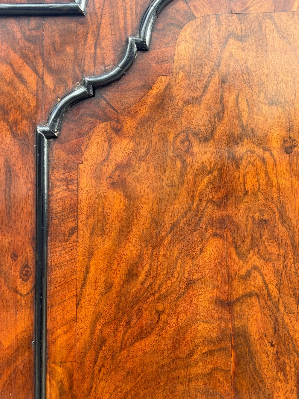 An 18th-century George I walnut bureau bookcase featuring arched panelled upper doors, a slant-front desk, and graduated lower drawers. View XVI