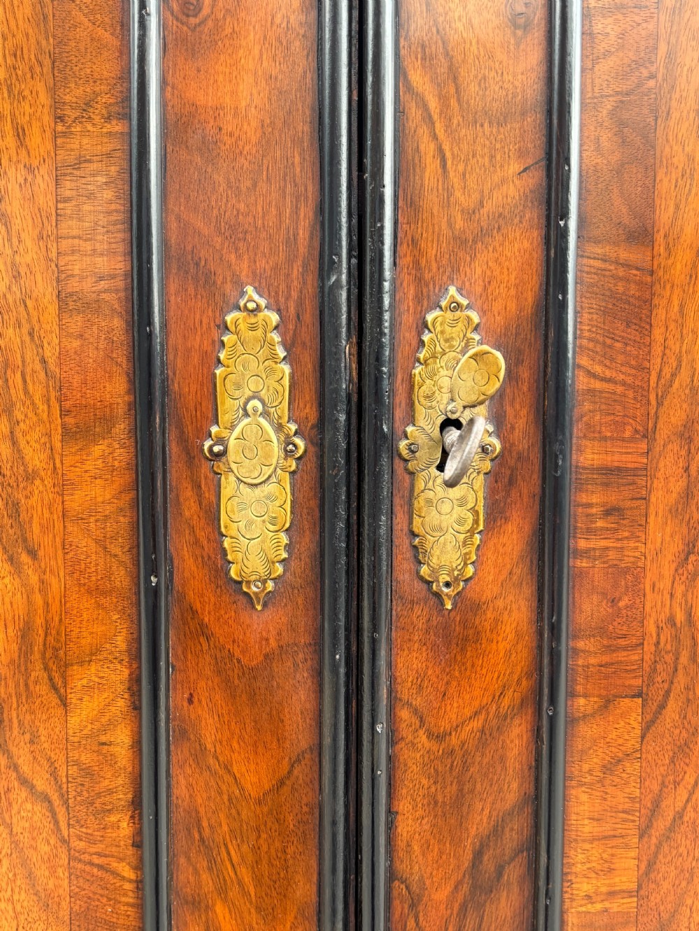 An 18th-century George I walnut bureau bookcase featuring arched panelled upper doors, a slant-front desk, and graduated lower drawers. View XVII
