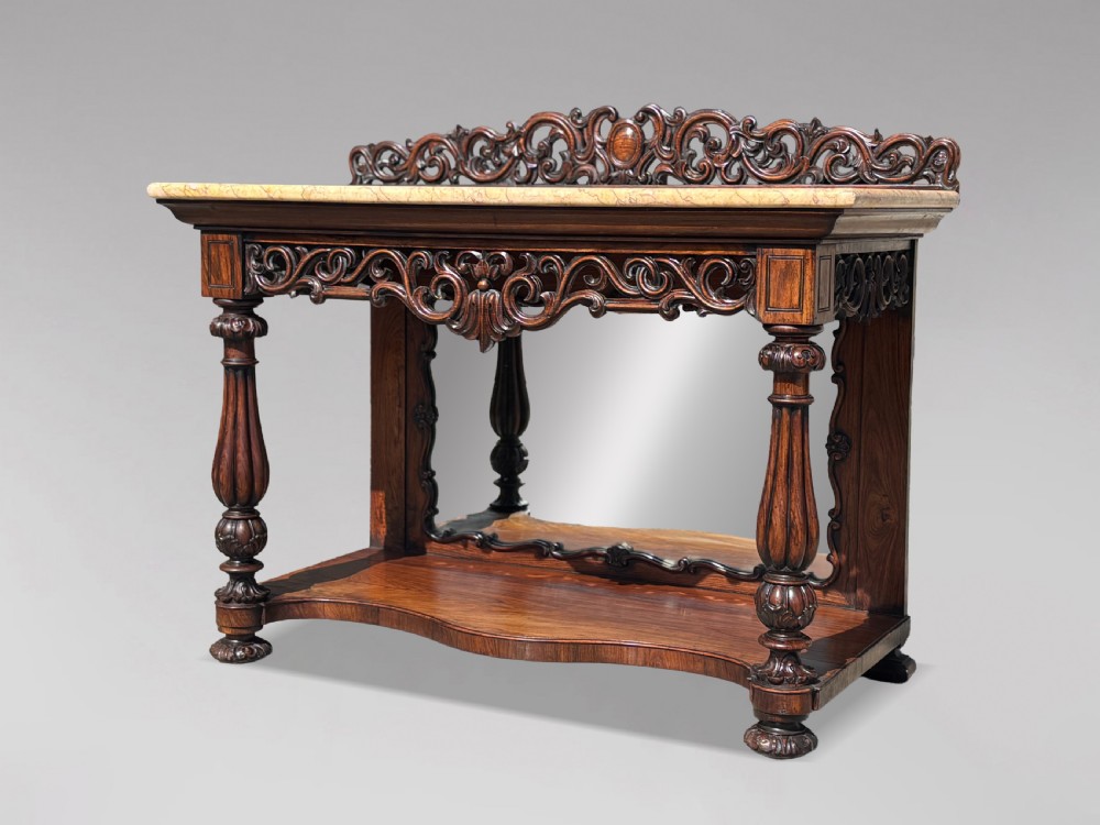 A 19th-century carved rosewood console table featuring a light marble top, elaborate pierced scrollwork frieze, mirrored back panel, and a shaped lower shelf. View III