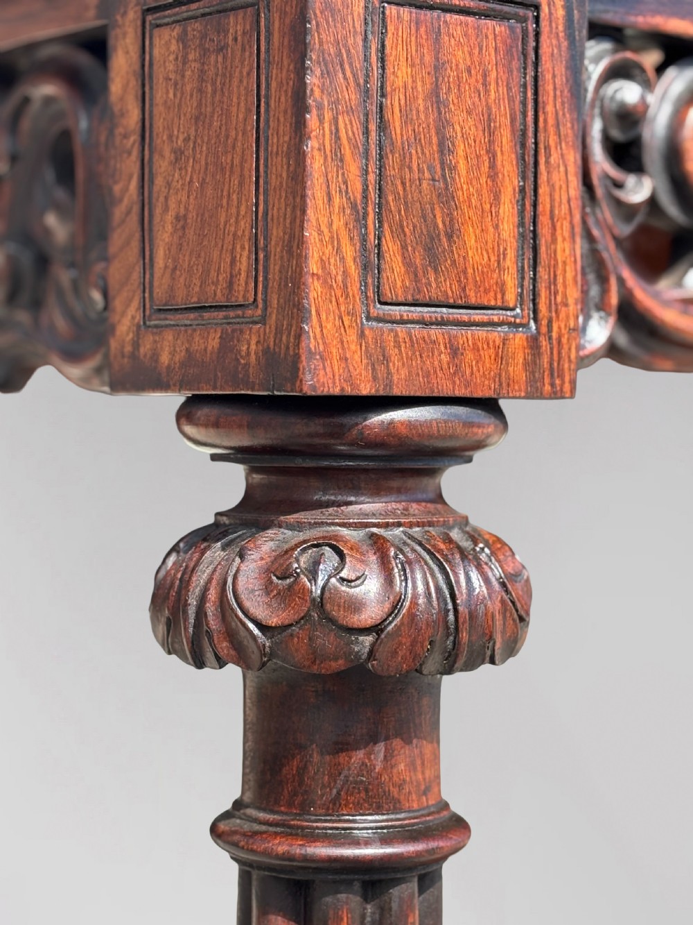 A 19th-century carved rosewood console table featuring a light marble top, elaborate pierced scrollwork frieze, mirrored back panel, and a shaped lower shelf. View IX