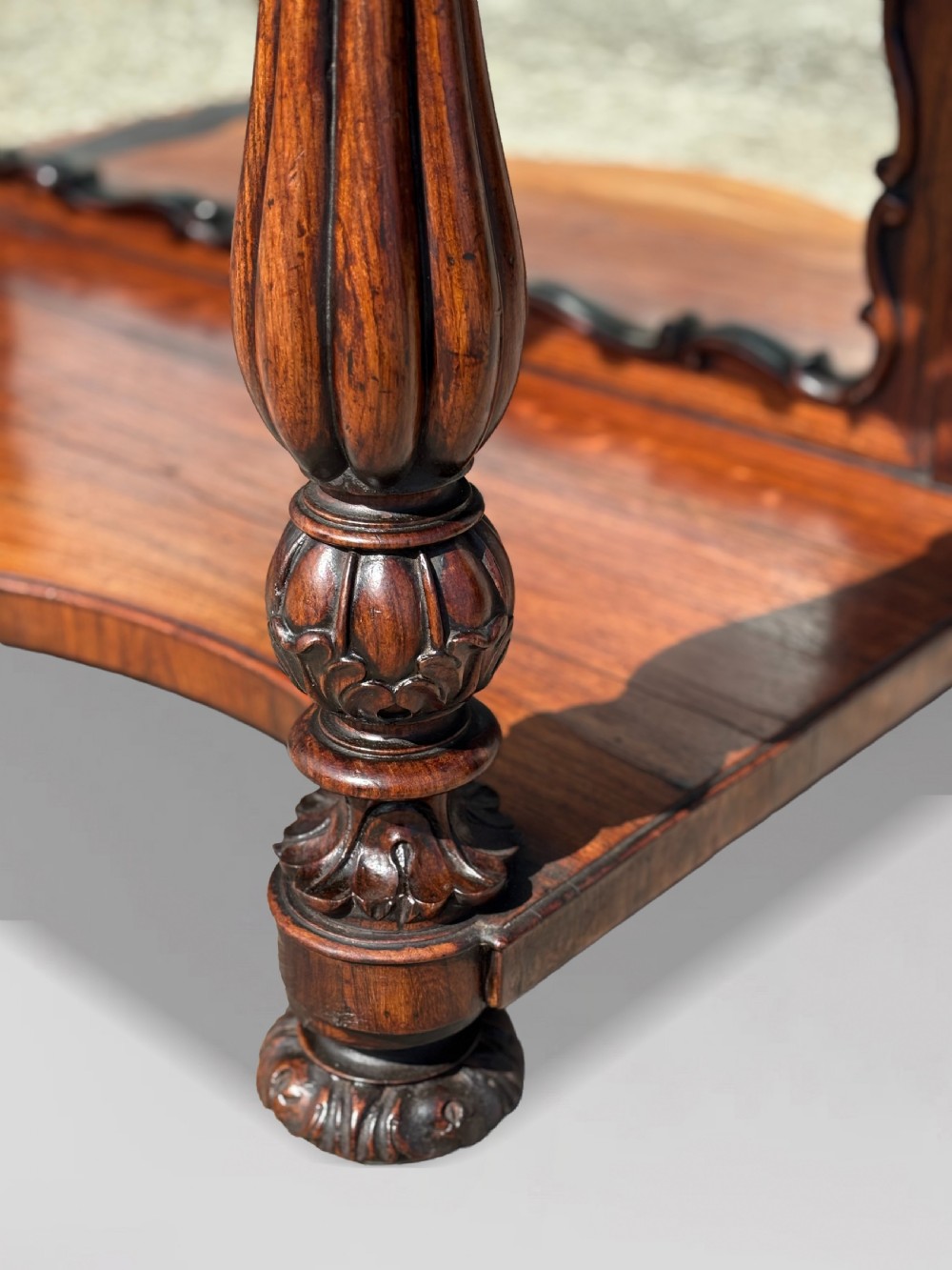 A 19th-century carved rosewood console table featuring a light marble top, elaborate pierced scrollwork frieze, mirrored back panel, and a shaped lower shelf. View X