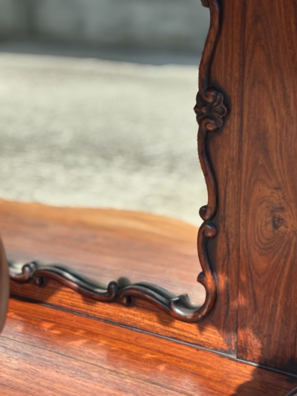 A 19th-century carved rosewood console table featuring a light marble top, elaborate pierced scrollwork frieze, mirrored back panel, and a shaped lower shelf. View XI