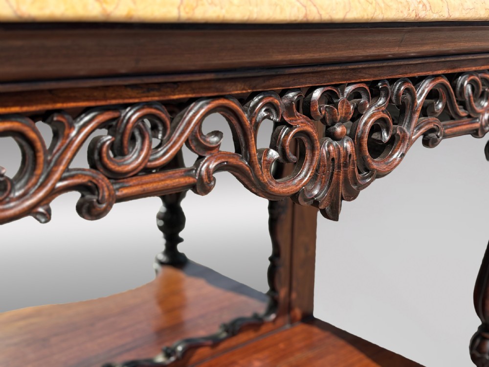 A 19th-century carved rosewood console table featuring a light marble top, elaborate pierced scrollwork frieze, mirrored back panel, and a shaped lower shelf. View XIII