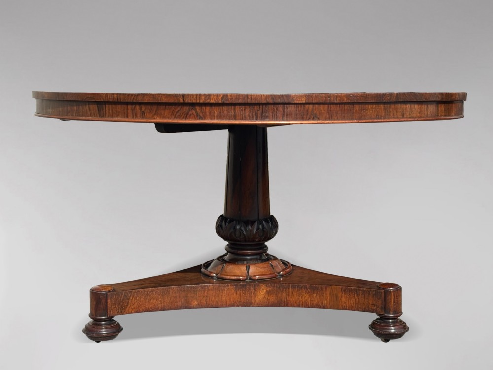 An early 19th-century William IV circular tilt-top centre table constructed from figured rosewood with a triform base. View IX