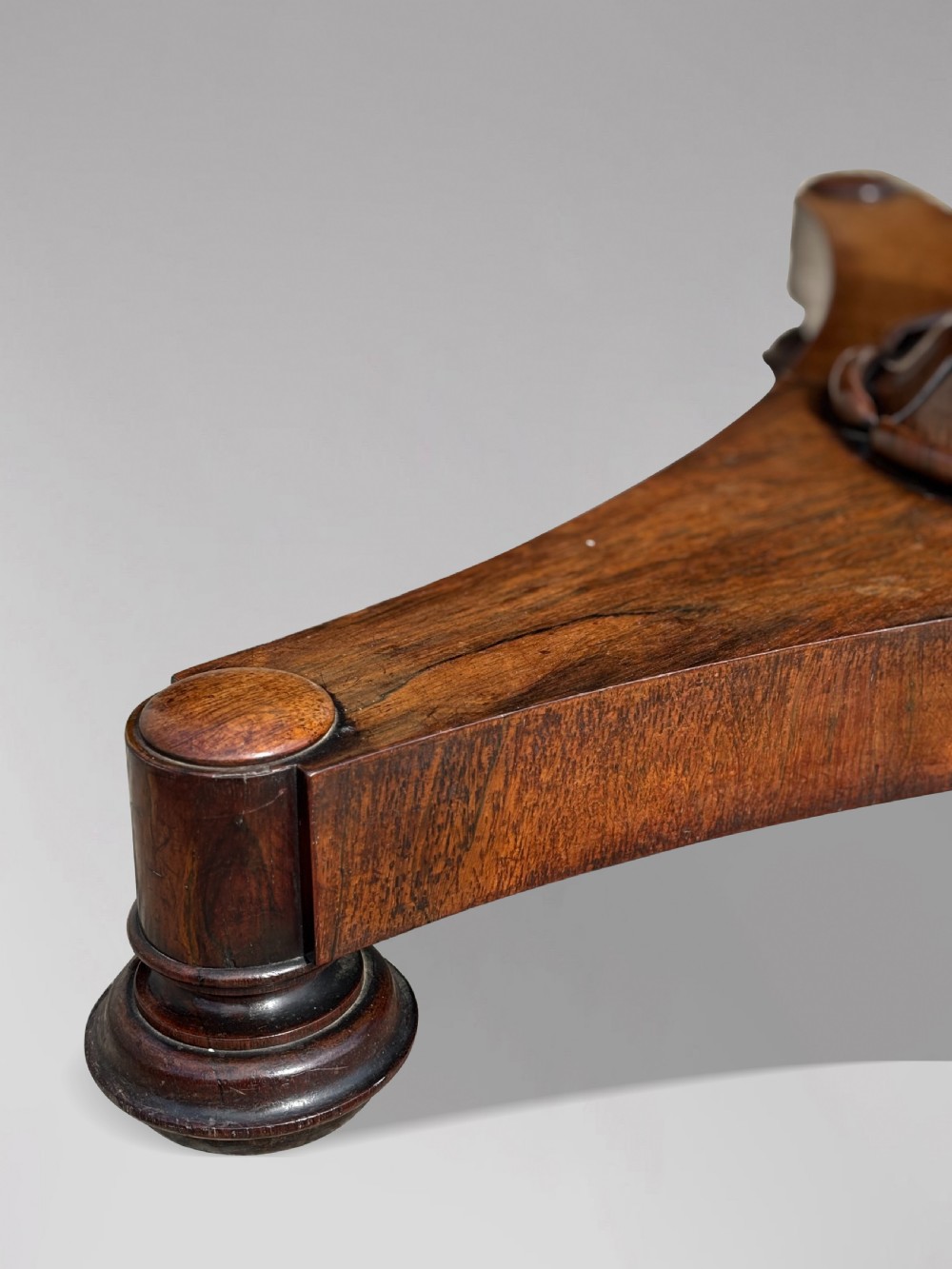 An early 19th-century William IV circular tilt-top centre table constructed from figured rosewood with a triform base. View XII