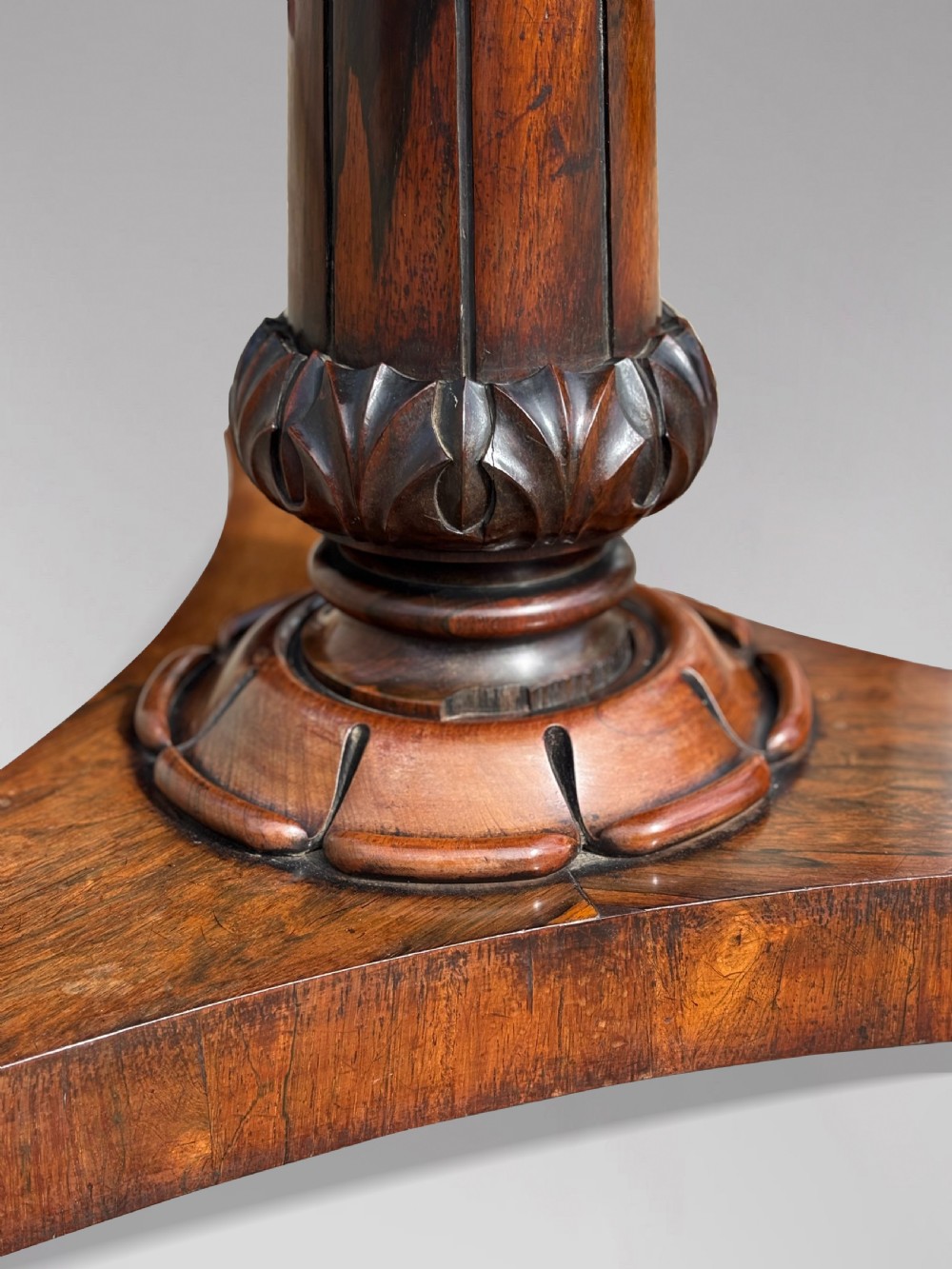 An early 19th-century William IV circular tilt-top centre table constructed from figured rosewood with a triform base. View XIII