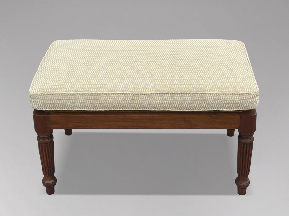 A 19th-century rectangular teak stool with fluted turned legs and a cream textured upholstered cushion top. View VIII