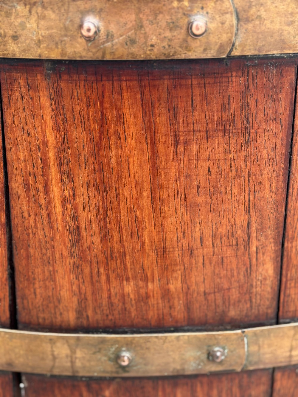 An 18th-century George III oval staved walnut wine cooler featuring twin brass binding bands, splayed legs, and an internal metal liner. View VIII