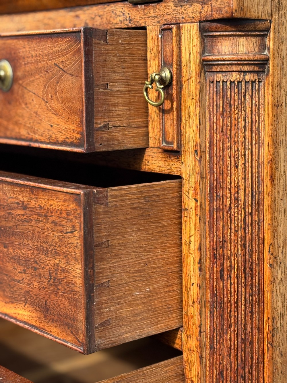 An 18th-century George III mahogany bureau featuring a sloping fall-front writing flap above four graduated drawers with brass handles and bracket feet. View VIII