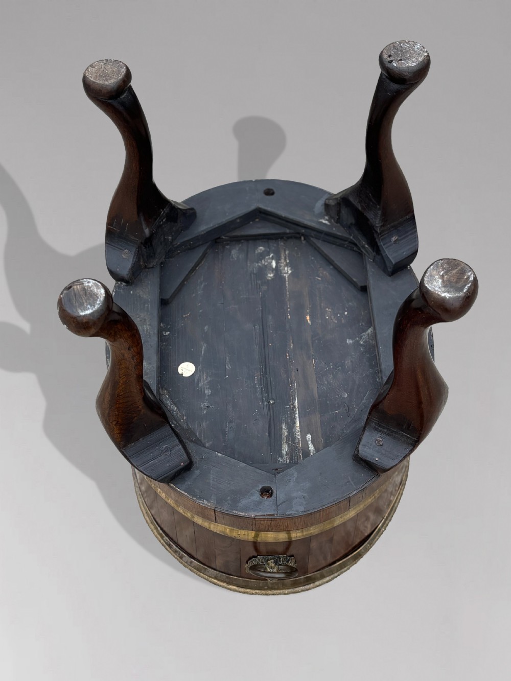 A pair of oval eighteenth-century Georgian mahogany wine coolers featuring brass banding, lion mask drop handles, metal liners, and cabriole legs. View IV