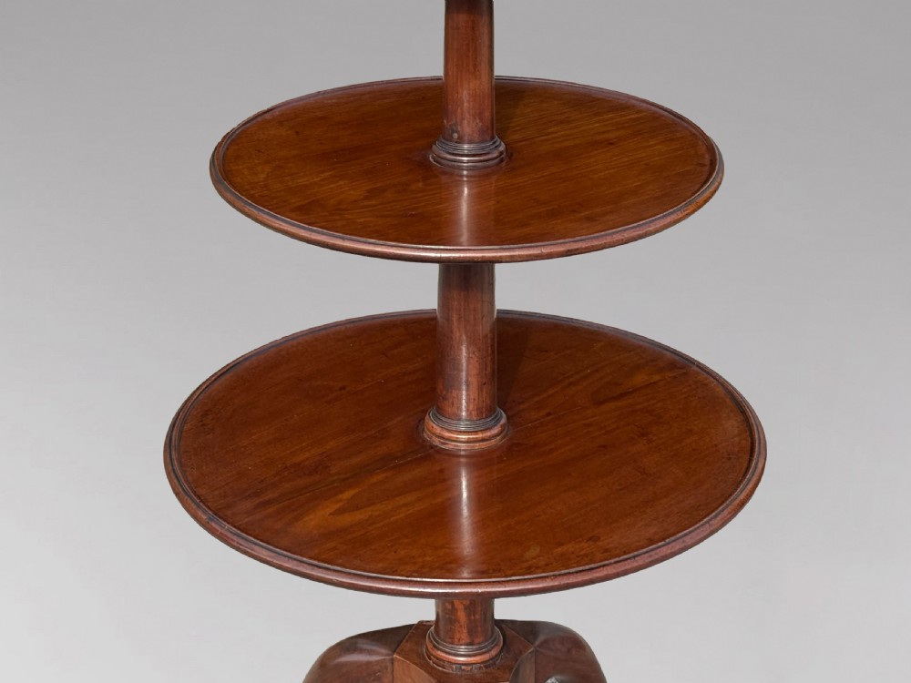 An 18th-century George III mahogany dumb waiter featuring three graduated circular tiers supported by turned columns on a tripod base. View IV