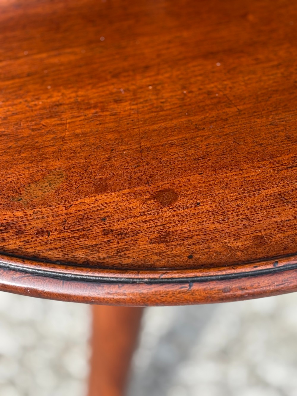 An 18th-century George III mahogany dumb waiter featuring three graduated circular tiers supported by turned columns on a tripod base. View IX