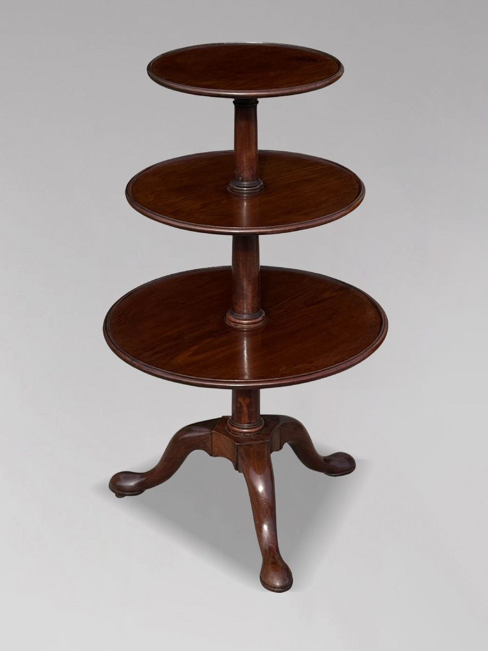 An 18th-century George III mahogany dumb waiter featuring three graduated circular tiers supported by turned columns on a tripod base. View XI