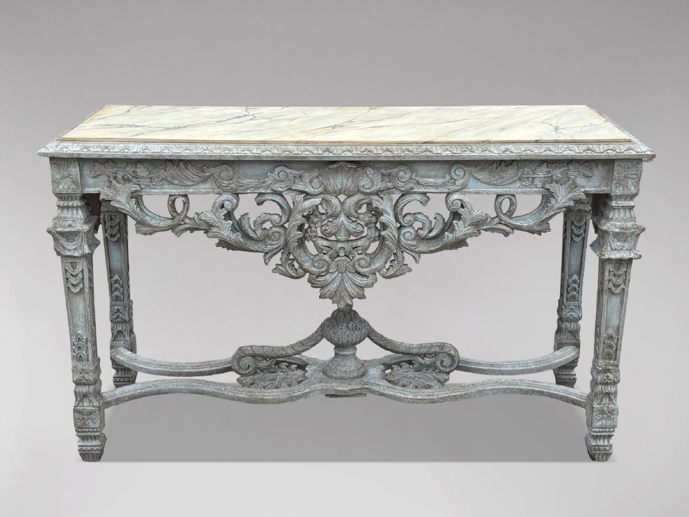 A carved Louis XIV style grey painted console table with an intricate aproned skirt, stretcher base, and faux marble top. View II