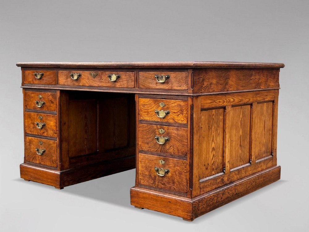 A Victorian pitch pine partners desk featuring a green leather inset writing surface, twin pedestals, and brass swan-neck handles. View III