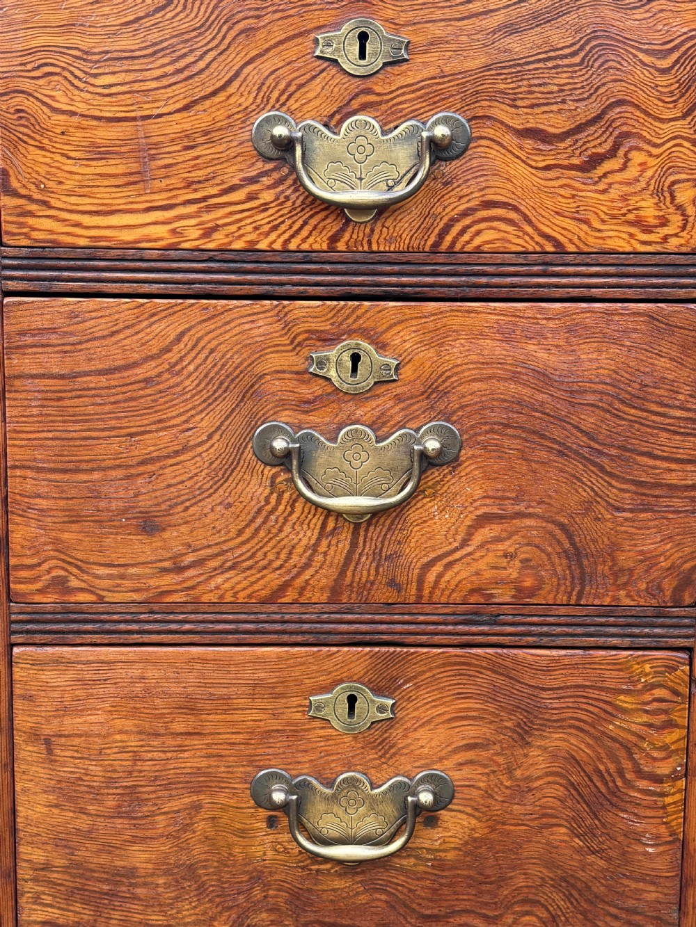 A Victorian pitch pine partners desk featuring a green leather inset writing surface, twin pedestals, and brass swan-neck handles. View V