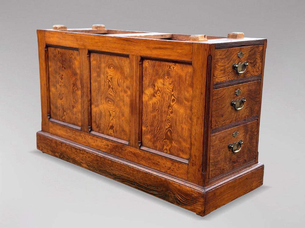 A Victorian pitch pine partners desk featuring a green leather inset writing surface, twin pedestals, and brass swan-neck handles. View VIII