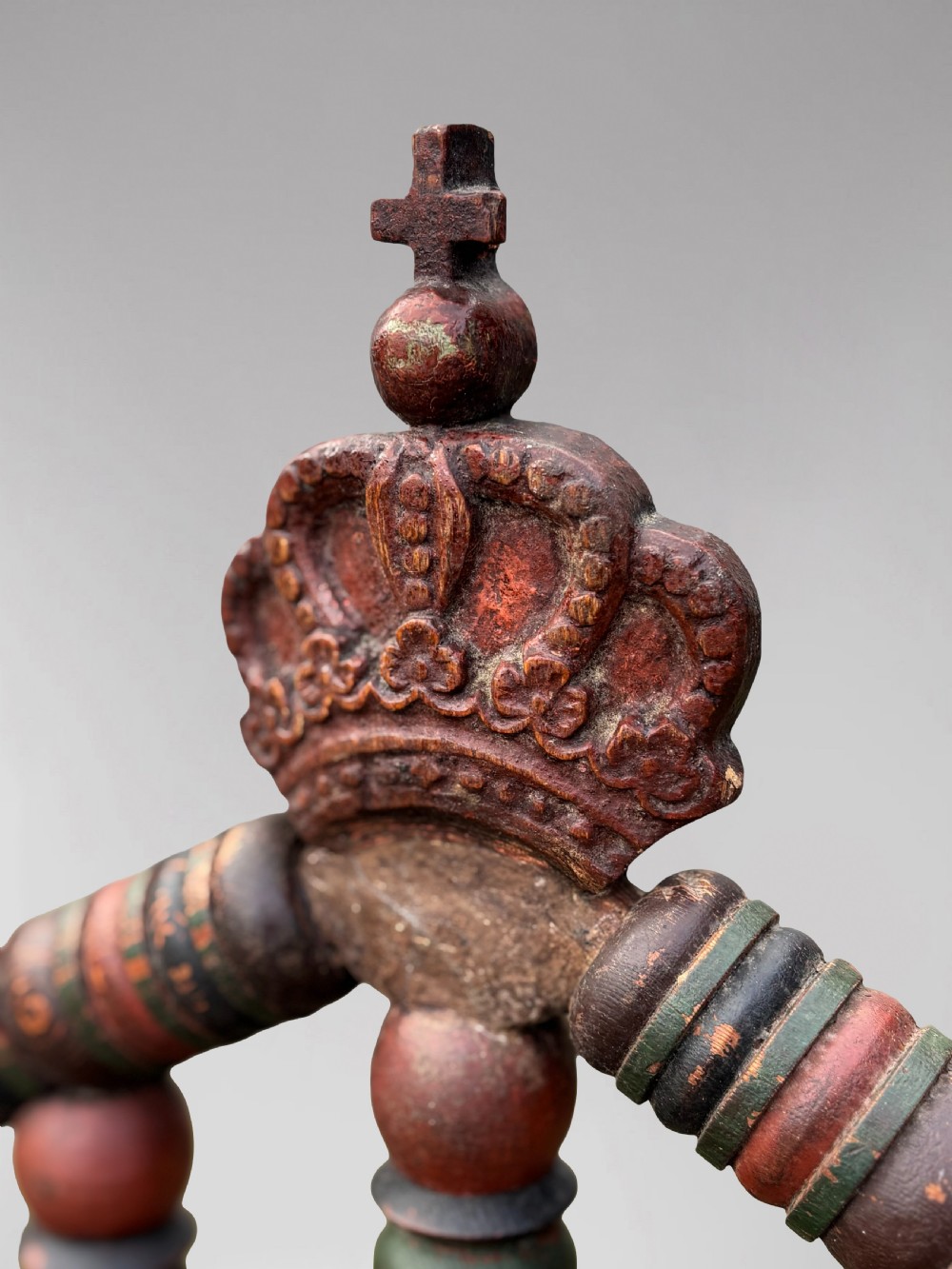 A 19th-century Swedish country throne armchair constructed with polychrome turned bobbins, a carved crown top finial, and a light cushion. View VI