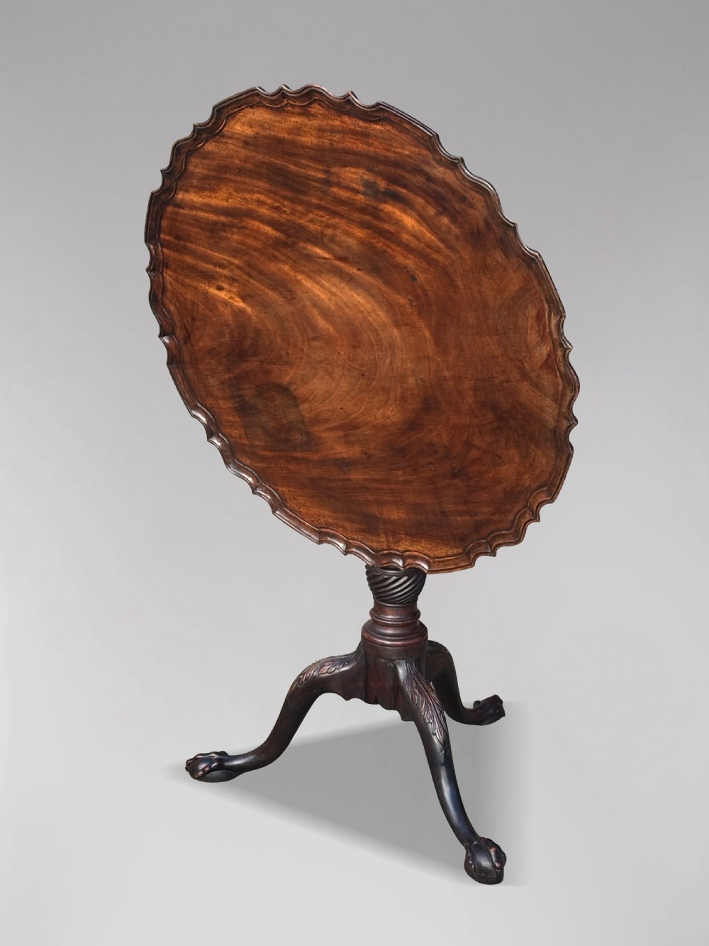 An 18th-century George III mahogany tilt-top tripod table featuring a carved piecrust rim, a fluted column, and cabriole legs ending in claw and ball feet. View II