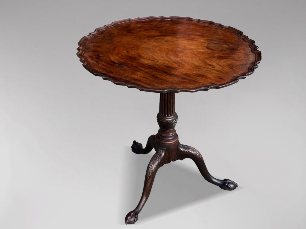An 18th-century George III mahogany tilt-top tripod table featuring a carved piecrust rim, a fluted column, and cabriole legs ending in claw and ball feet. View III