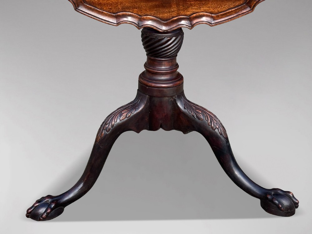 An 18th-century George III mahogany tilt-top tripod table featuring a carved piecrust rim, a fluted column, and cabriole legs ending in claw and ball feet. View VII