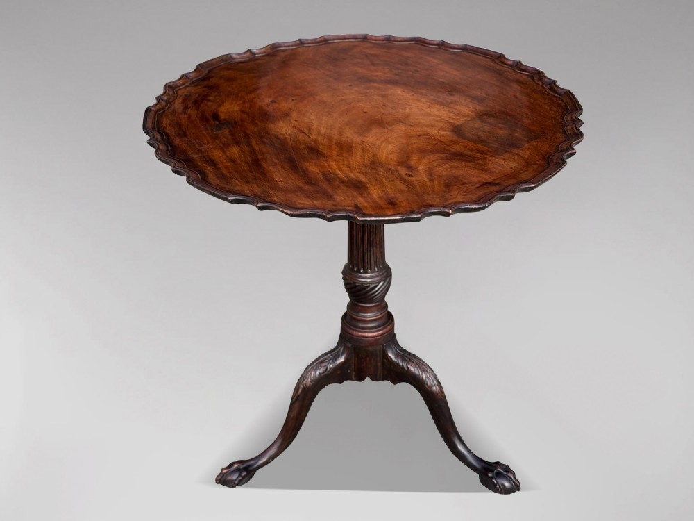 An 18th-century George III mahogany tilt-top tripod table featuring a carved piecrust rim, a fluted column, and cabriole legs ending in claw and ball feet. View IX
