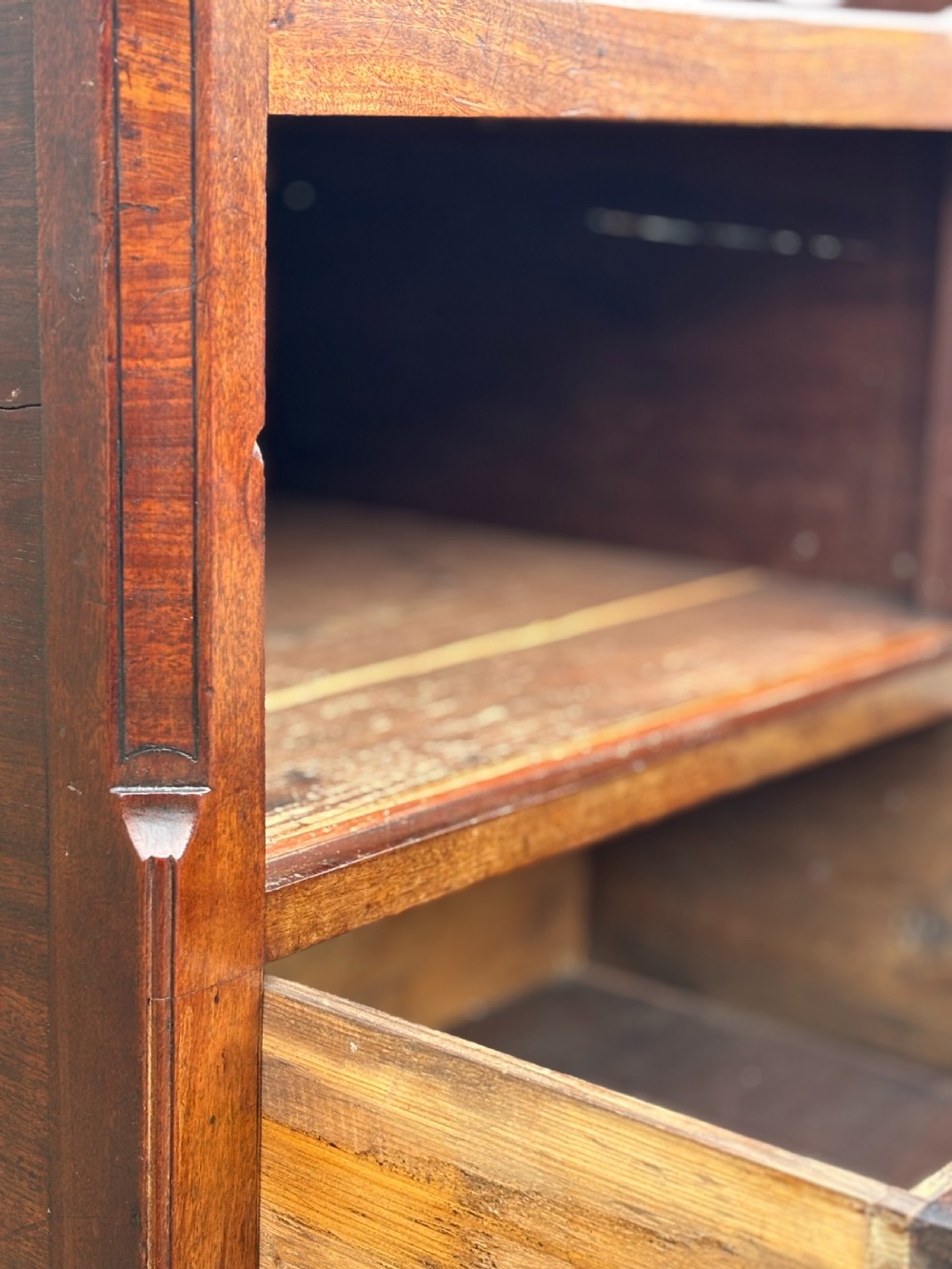 An 18th-century George III mahogany tray-top commode featuring shaped gallery sides, a cupboard with twin panel doors, a lower drawer with brass swan-neck handle, and square legs. View VII