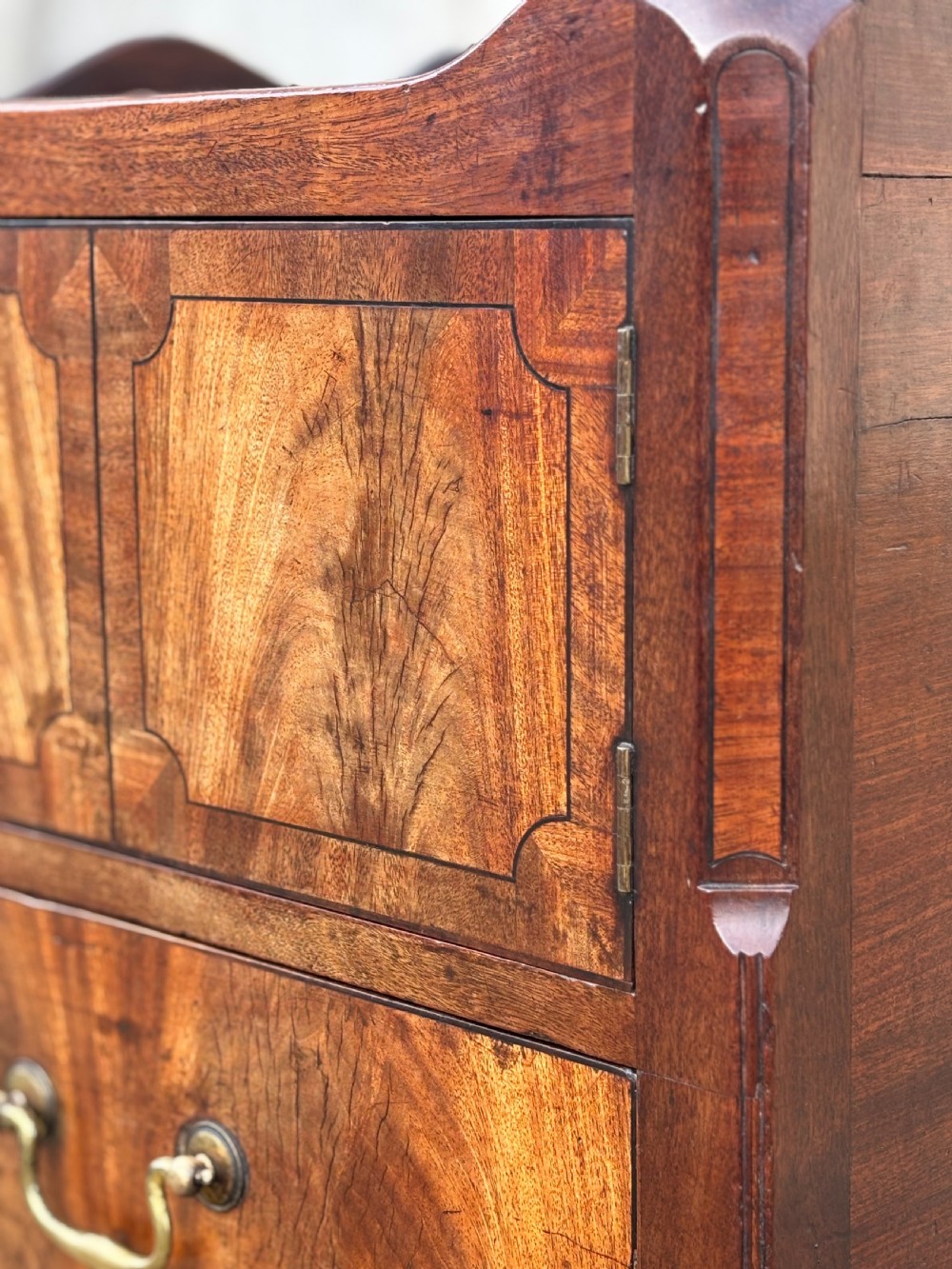 An 18th-century George III mahogany tray-top commode featuring shaped gallery sides, a cupboard with twin panel doors, a lower drawer with brass swan-neck handle, and square legs. View IX