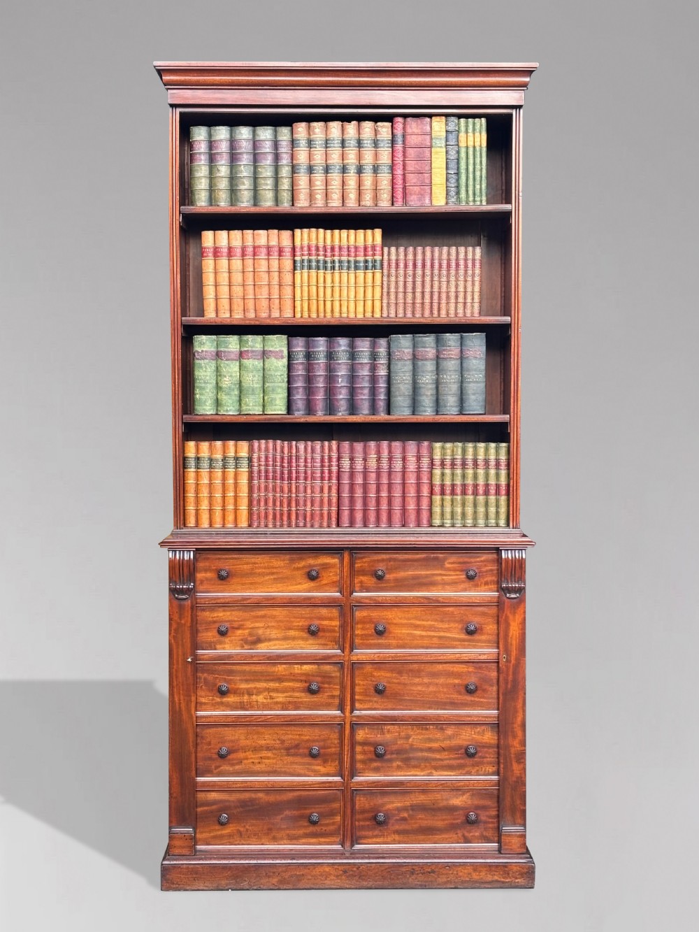 A nineteenth-century mahogany open library bookcase featuring a Wellington chest base with ten small drawers and open adjustable upper shelves. View II